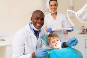Dentist performing dental cleaning for a child in a kid-friendly clinic